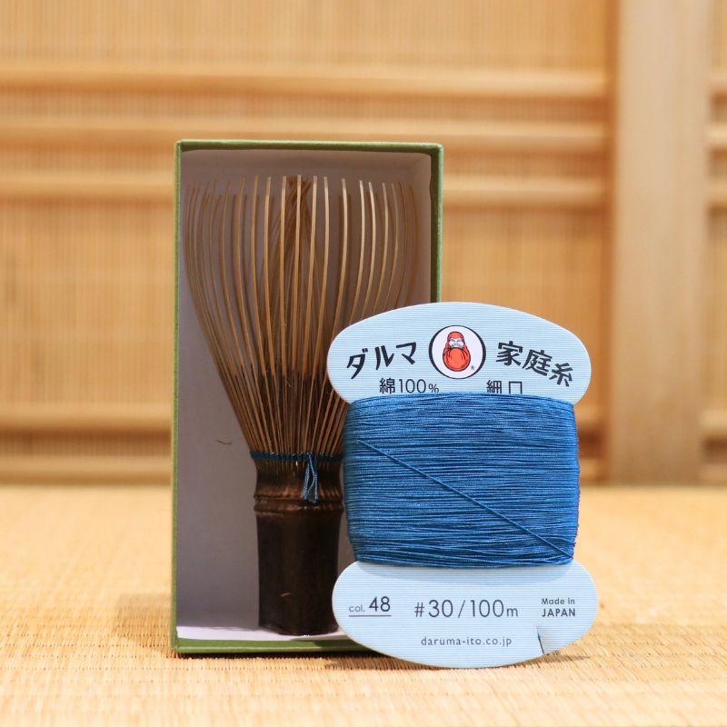 Black bamboo Takayama chasen by Ryosai Kubo displayed with a spool of Teal Blue #48 thread