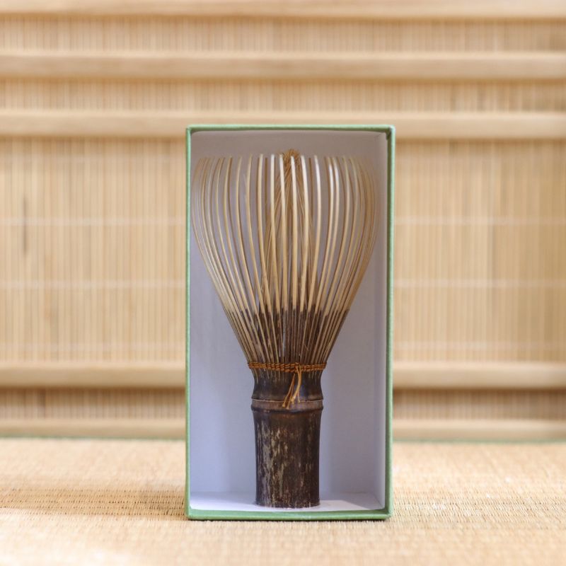 Ryosai Kubo black bamboo Takayama chasen with Bronze #19 thread displayed upright inside its green presentation box