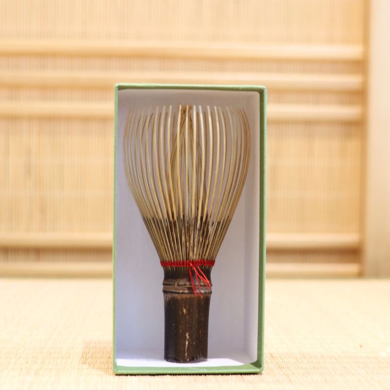 Ryosai Kubo black bamboo Takayama chasen with Maroon #5 thread displayed upright inside its green presentation box