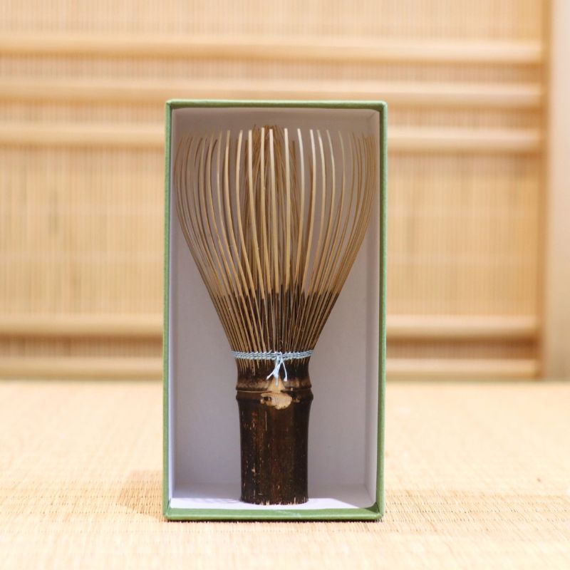 Ryosai Kubo black bamboo Takayama chasen with Pale Blue #27 thread displayed upright inside its green presentation box