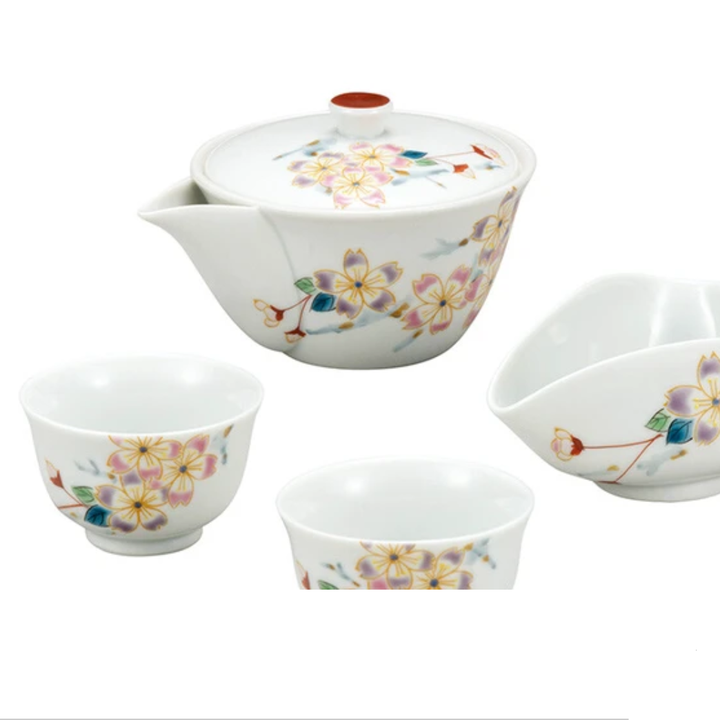 Set of ceramic teaware with floral patterns on a white background