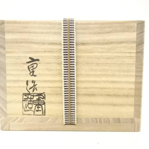 Exterior of the original wooden storage box with Japanese calligraphy, a woven securing cord, and a stamped mark for the Setsugekka chawan.