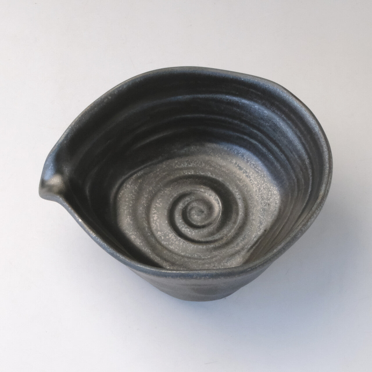 Top view of the Mino Ware katakuchi matcha bowl showing its pouring spout and silver-gray spiral glaze inside.