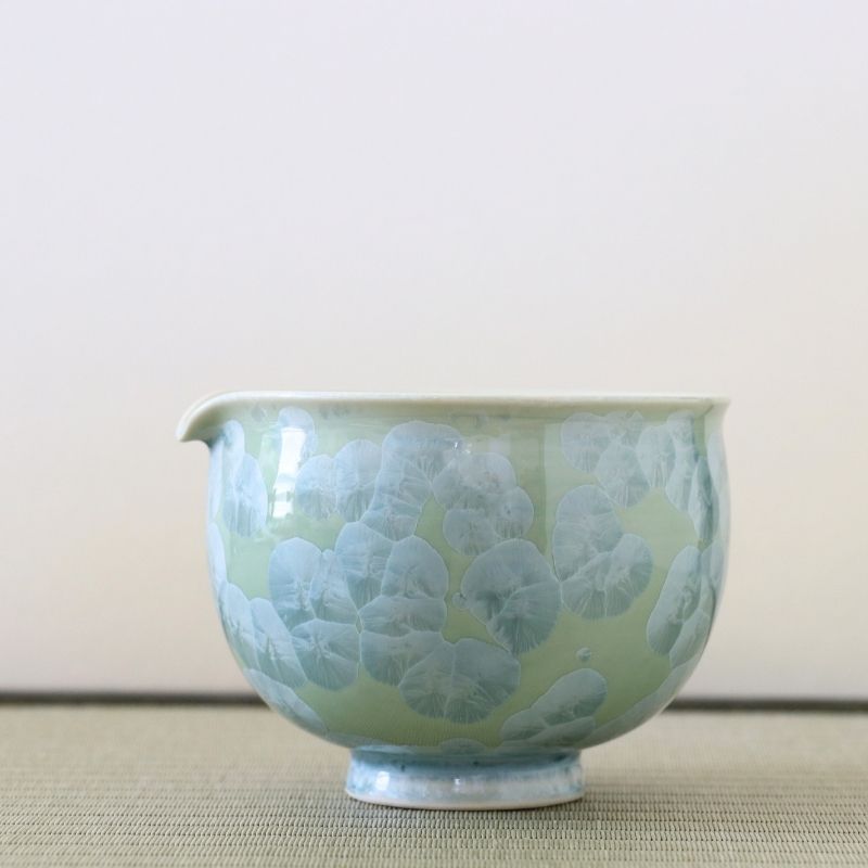 Tōan katakuchi matcha latte pouring bowl featuring a soft green Hana-Kesshō flower crystal glaze with pale blue-green crystalline patterns