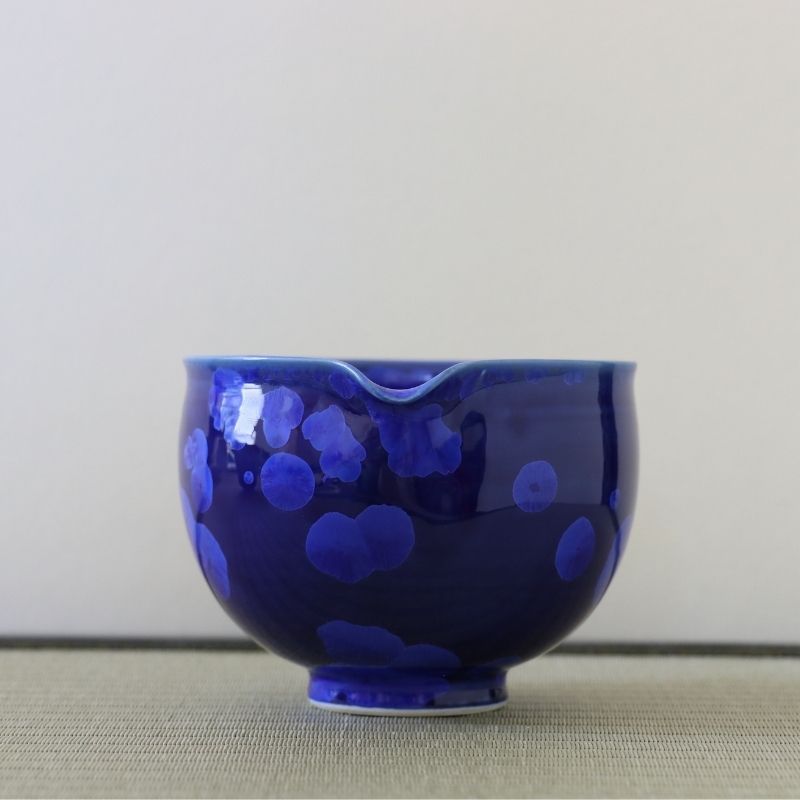 Spout view of the Tōan lapis blue katakuchi matcha latte bowl highlighting the pouring lip and lighter blue flower crystal glaze patterns