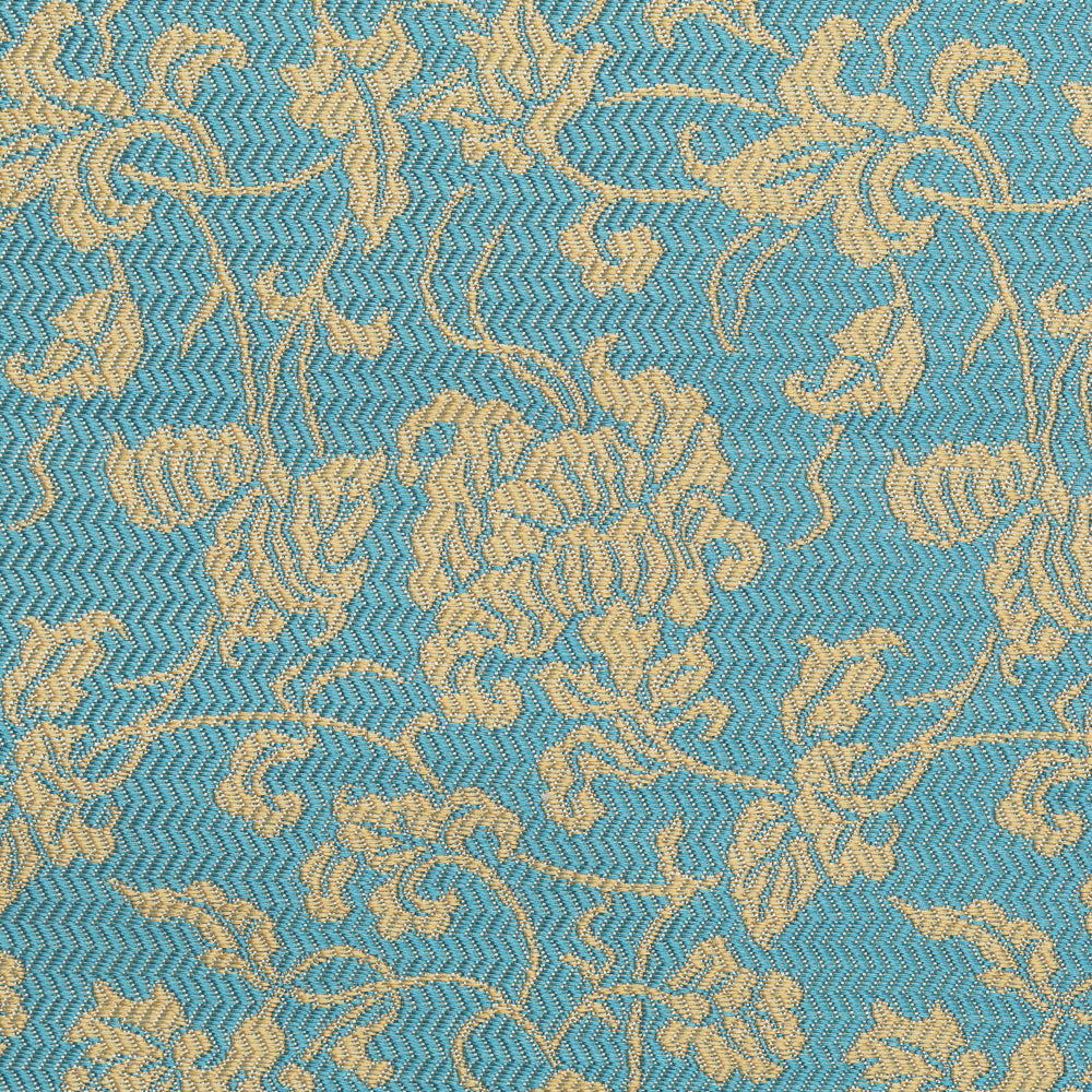 Close-up of scrolling vines and stylized floral motifs woven in gold-toned silk on a turquoise-blue ground.