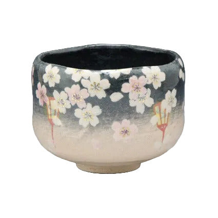 Yoizakura Raku-style Kyo Ware matcha bowl with pale pink and white evening cherry blossoms against a dark glaze