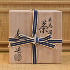 Gift box with a blue ribbon on a traditional Japanese tatami mat background