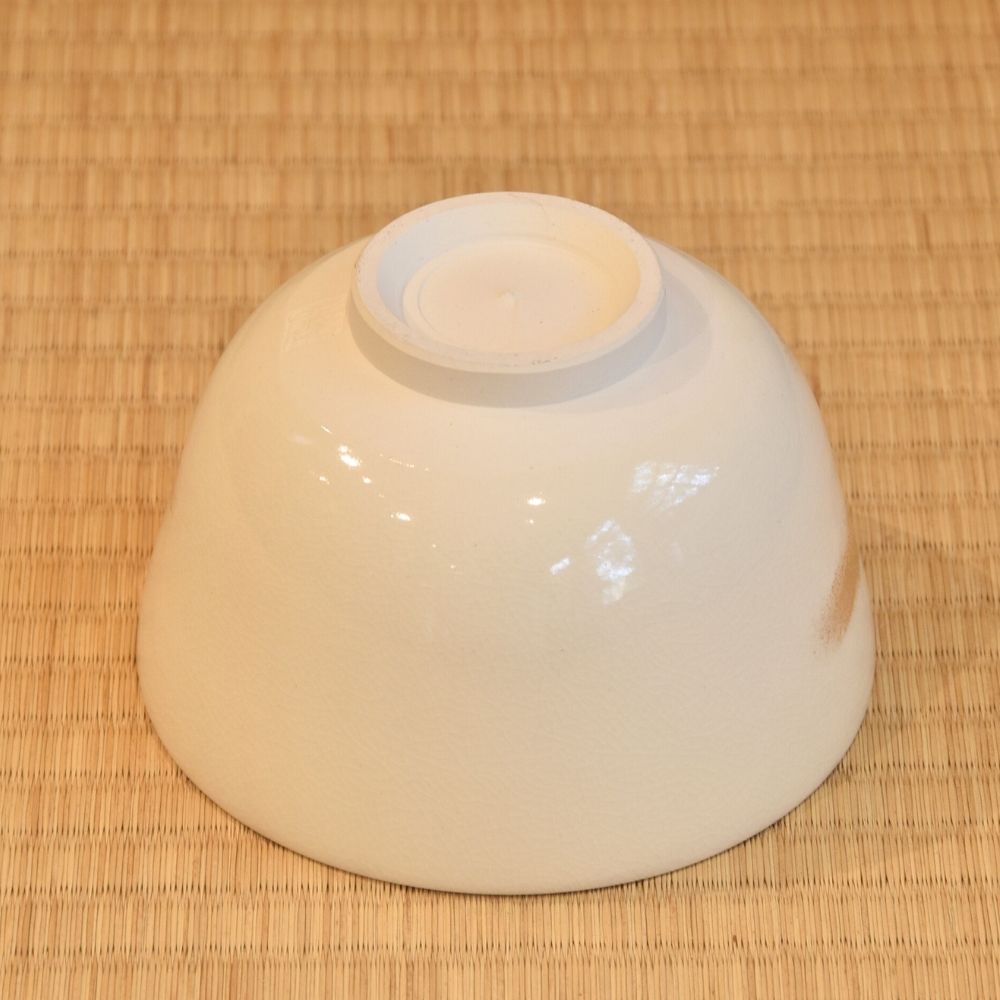 White ceramic bowl on a woven mat