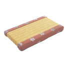 Yellow mattress with red and white floral pattern on a white background