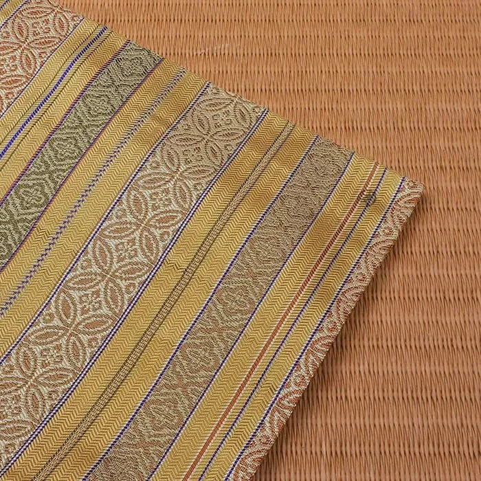 Striped fabric with geometric pattern on a textured brown background