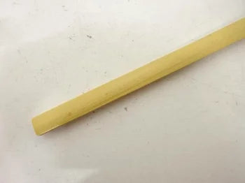 Long, thin wooden stick on a light gray background