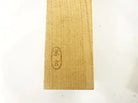 Wooden cutting board with engraved text on a white background