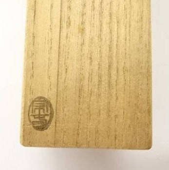 Wooden block with a logo on a white background