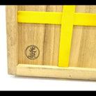 Wooden box with a yellow ribbon and a logo on a white background