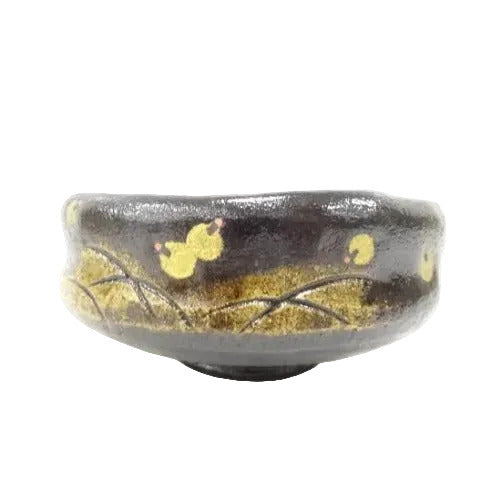 Ceramic bowl with gold leaf design on a white background