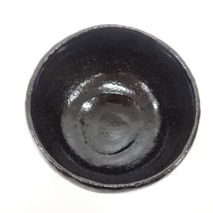 Black ceramic bowl on a white background