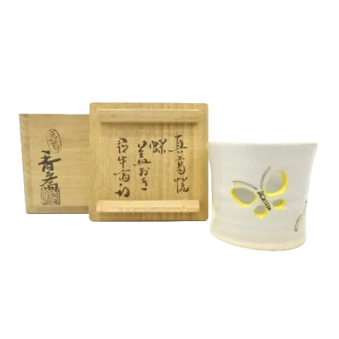 Ceramic mug with butterfly design and wooden tray with Japanese text on a white background