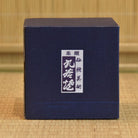 Blue box with a white label featuring Japanese text on a woven background