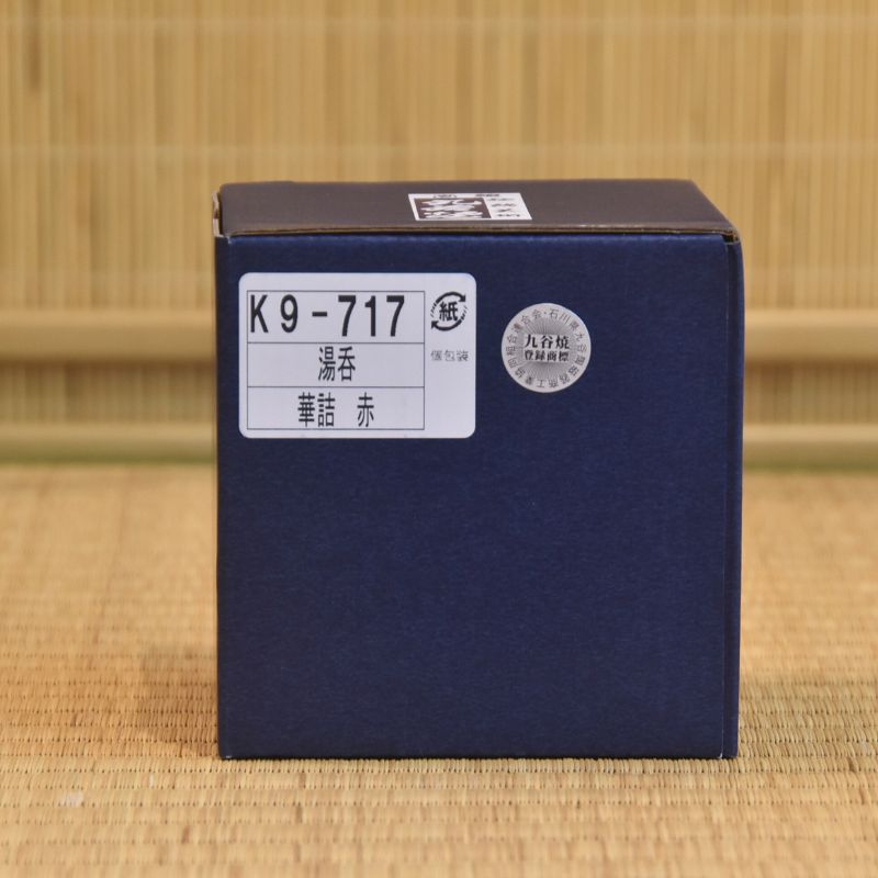 Blue box with a label on a woven mat background