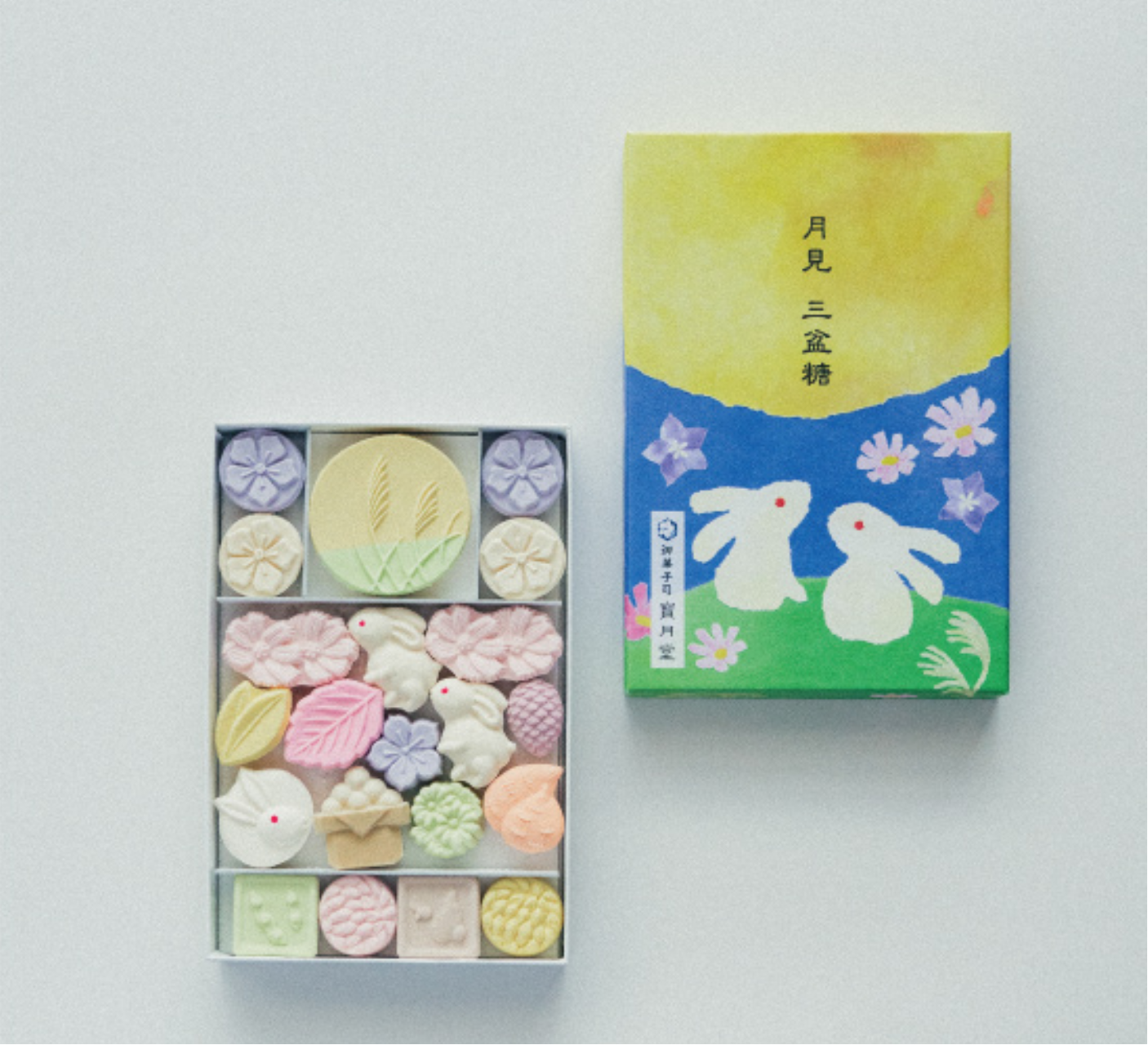 Box of colorful candy with a decorative box on a white background