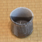 Ceramic cup on a woven mat