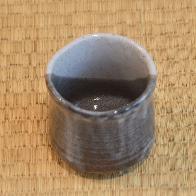 Ceramic cup on a woven mat
