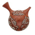 Ceramic teapot with floral patterns on a white background