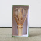 Japanese tea whisk with mustard-colored thread by Kubo Ryosai