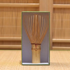 Bamboo whisk in a box with a wooden background
