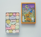 Colorful Halloween-themed candy set with a decorative box on a light gray background