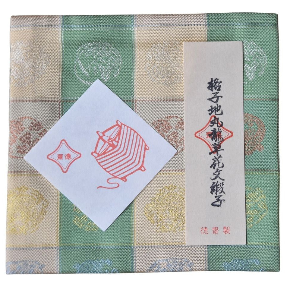 Textile product with a ball of dragon design and text on a checkered background