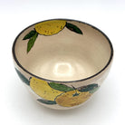 Top interior view of the Kyo-yaki yuzu chawan showing its warm ivory glaze and hand-painted yellow yuzu fruit and green leaves around the rim