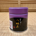 Black container with purple lid on a woven mat