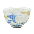 Ceramic bowl with wave design on a gray background
