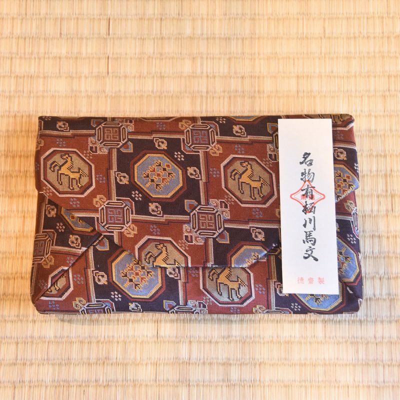 Decorative horse pattern fabric Sukiyabukuro on a woven mat