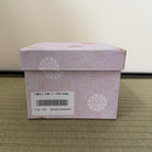 Decorative box with floral patterns on a beige background