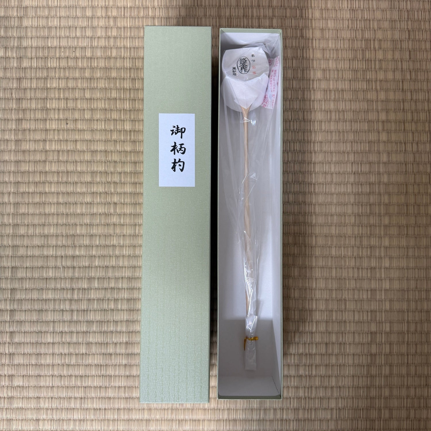 Decorative item in a box with a label on a textured surface