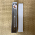 Spoon with a small container on a bamboo mat