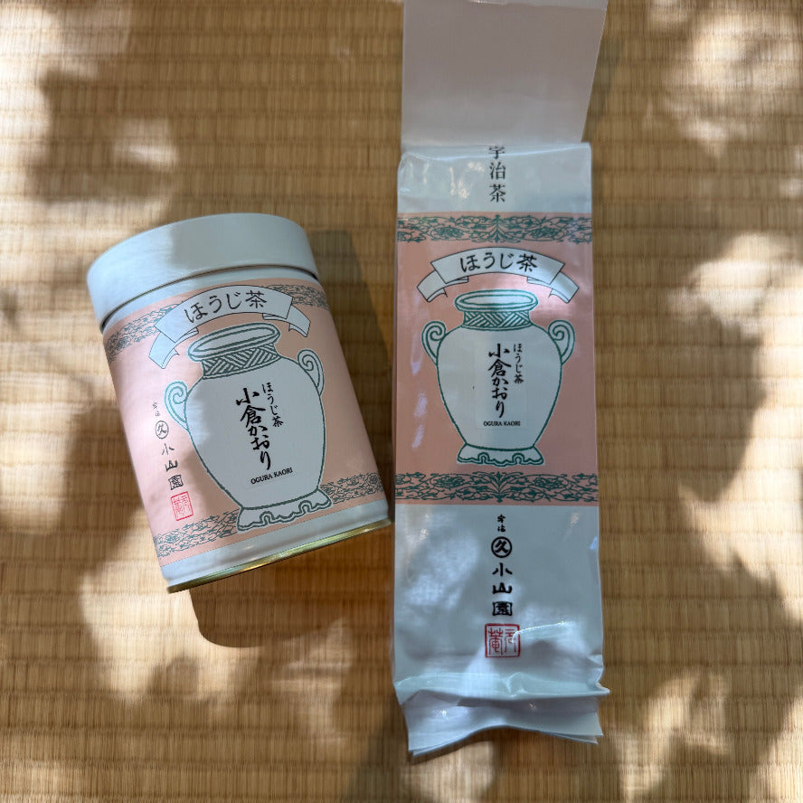 Tea canister and packaging on a woven surface