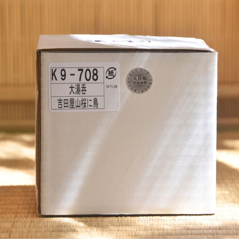 White box with a label on a wooden surface