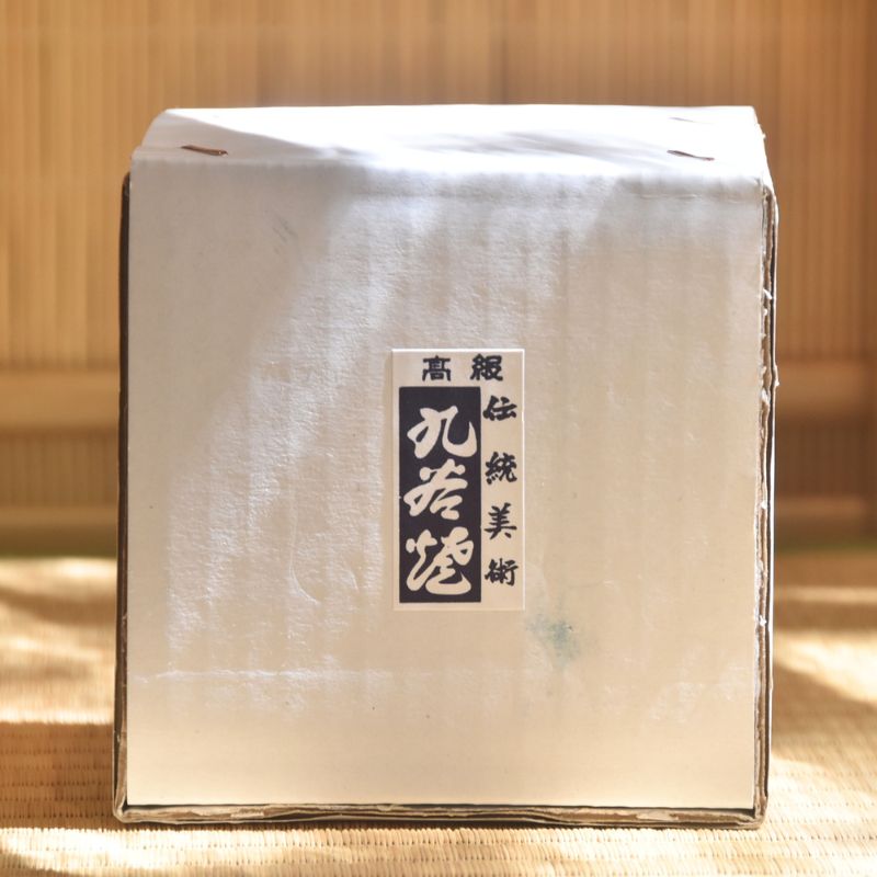 Square box with a label on a wooden surface
