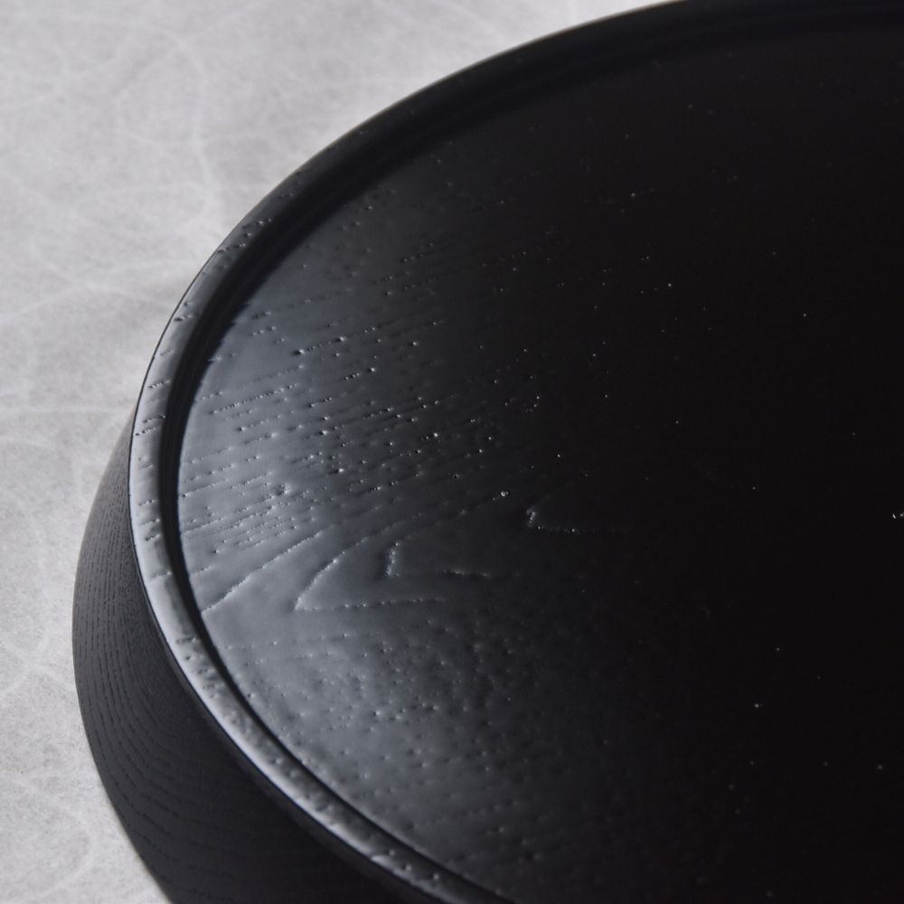 Close-up of a textured black surface on a gray background