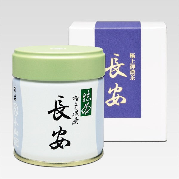 A canister of Marukyu Koyamaen Ceremonial Grade Matcha with Japanese characters printed on it, alongside its packaging box.