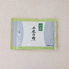 A canister of Chiginoshiro Matcha powder, with Japanese characters displayed on the label.