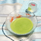 Matcha in a glass matchabowl with crab design on a patterned tablecloth