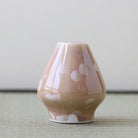 Matcha whisk stand holder with white patterns on a light gray surface