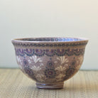 Decorative ceramic bowl with floral patterns on a neutral background