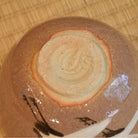 Ceramic bowl with a textured surface on a wooden background