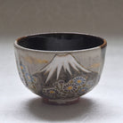 Ceramic cup with Mount Fuji and floral design on a white background